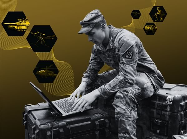 Soldier sitting down and typing on a laptop